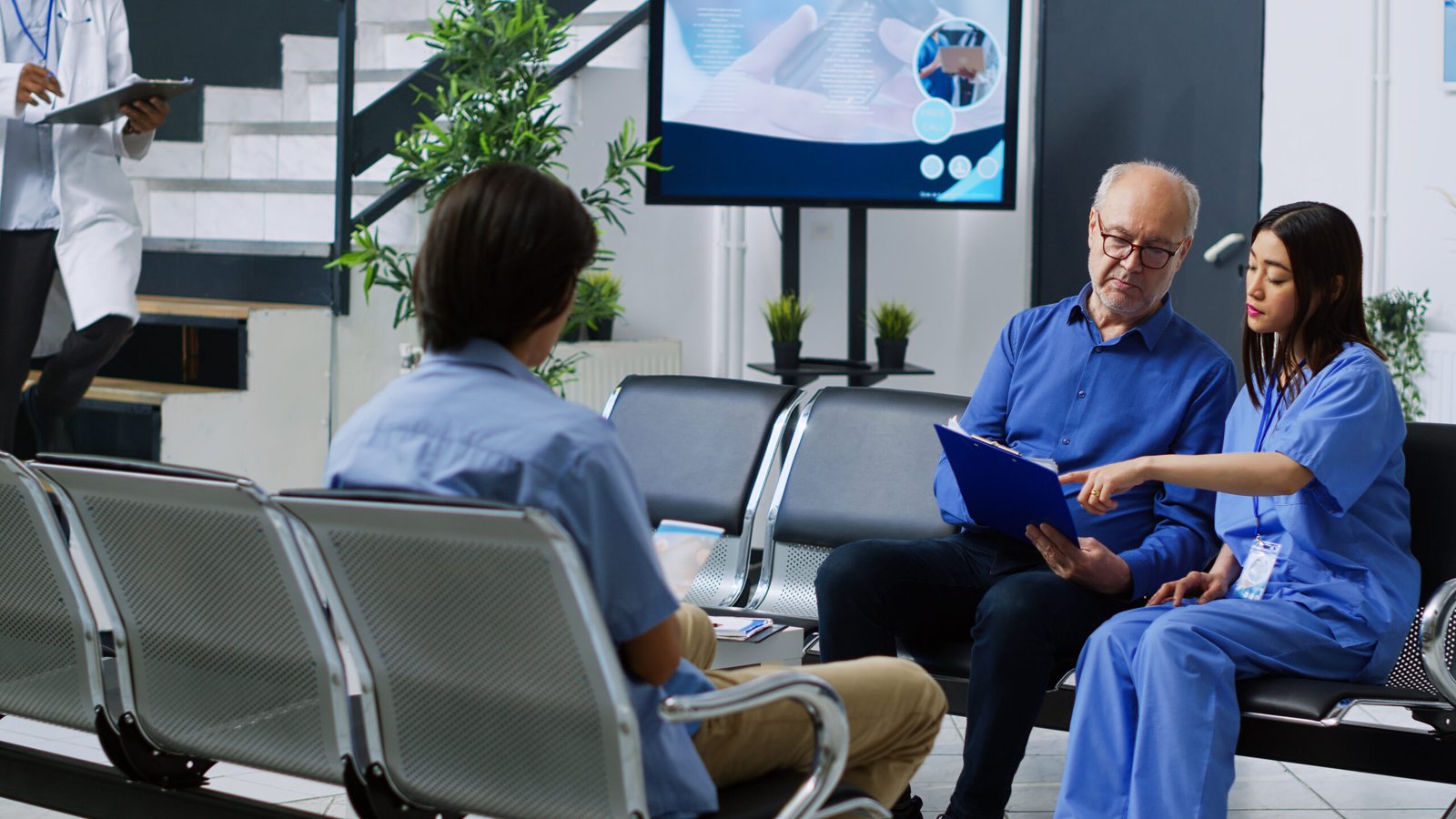 group-people-meeting-with-monitor-showing-blue-lab-coat-man-blue-scrubs